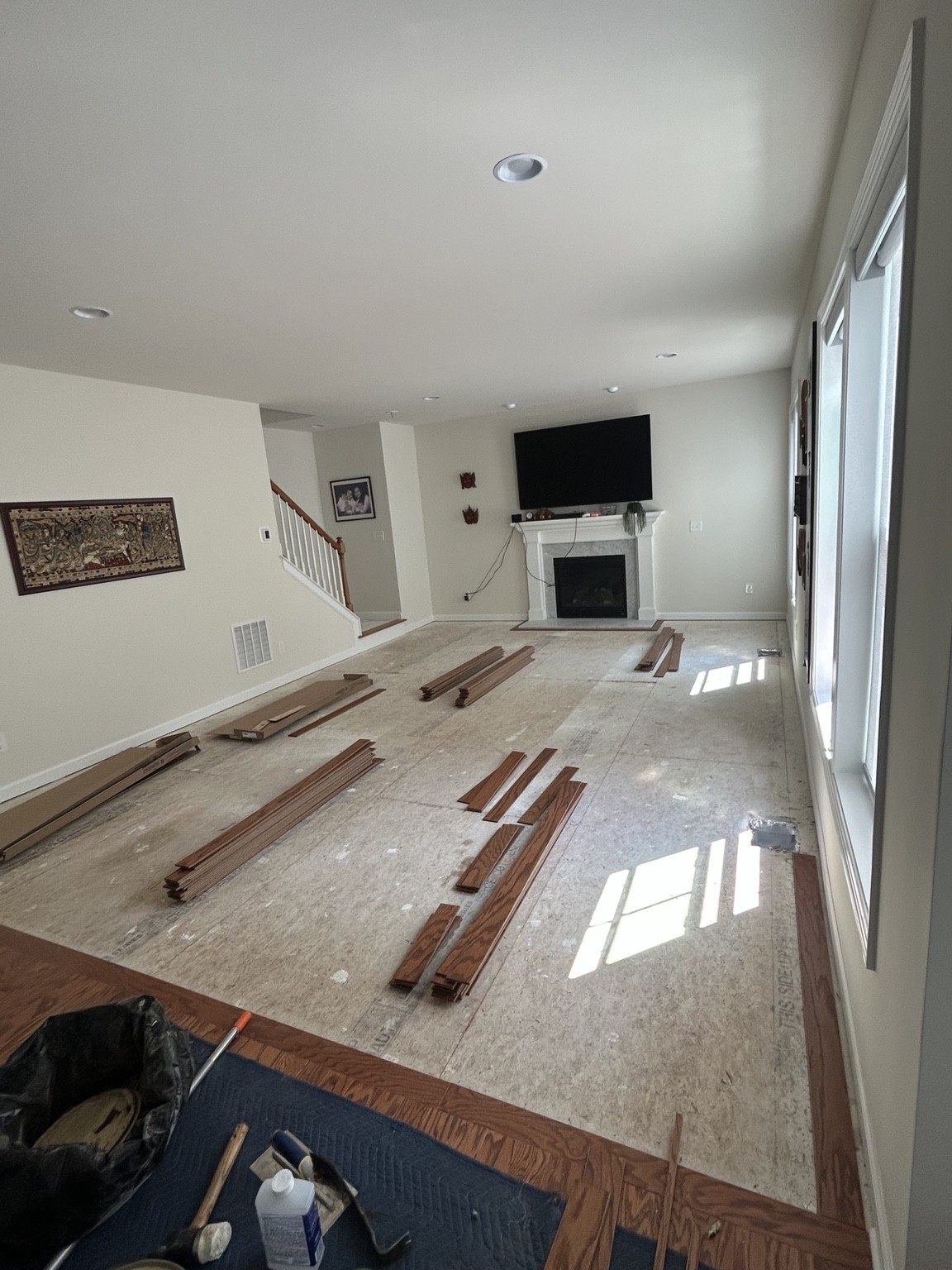 Engineered hardwood · Glue-down installation in progress